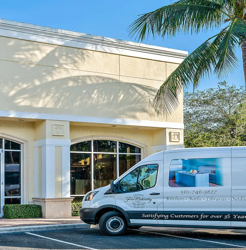 storefront with 3 vans parked in front